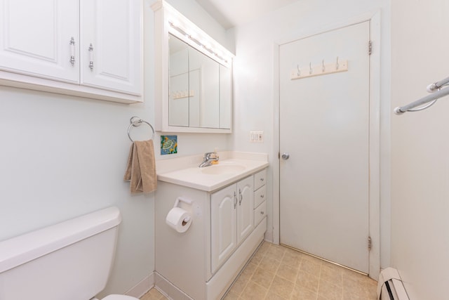 bathroom featuring vanity, a baseboard radiator, and toilet