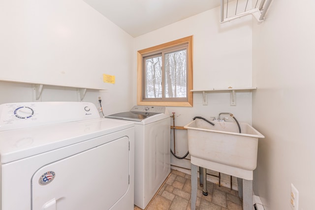 laundry room featuring sink, a baseboard radiator, and independent washer and dryer