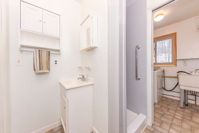 bathroom with vanity and washer / clothes dryer