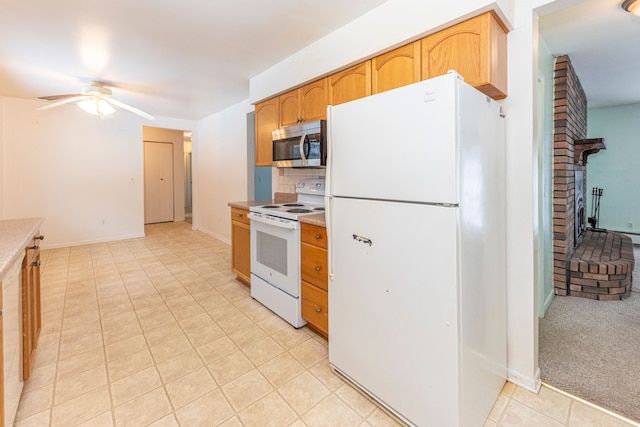 kitchen with ceiling fan, light colored carpet, white appliances, and decorative backsplash