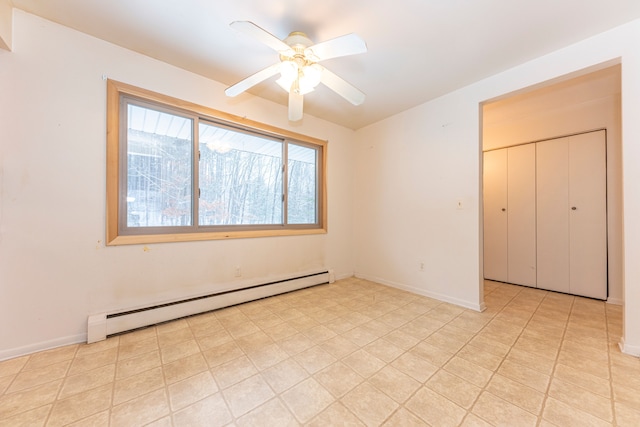 unfurnished bedroom featuring ceiling fan, a closet, and a baseboard heating unit