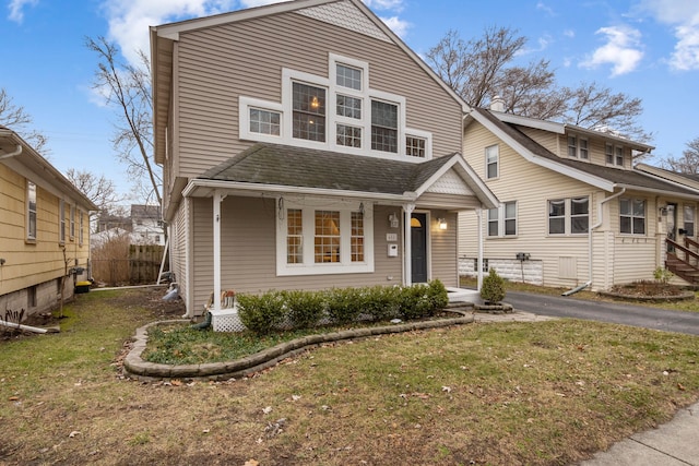 front facade with a front lawn and a porch