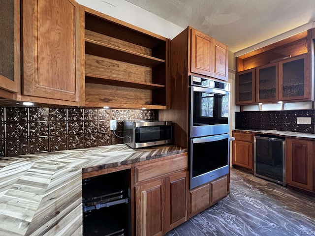 kitchen featuring wine cooler, decorative backsplash, and appliances with stainless steel finishes