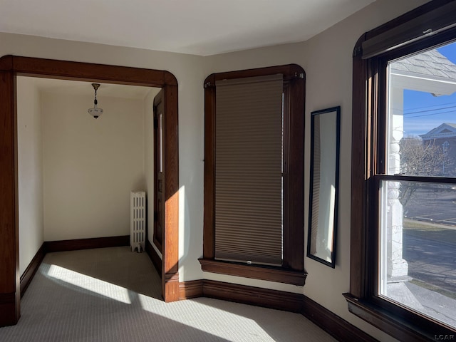 carpeted empty room with radiator