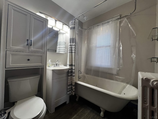 full bathroom with radiator, vanity, shower / bath combo, and toilet