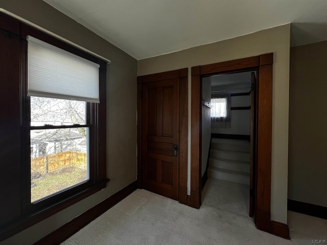 hallway with light colored carpet