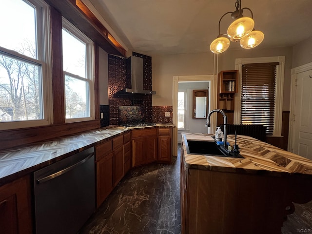 kitchen featuring sink, wall chimney exhaust hood, decorative backsplash, decorative light fixtures, and stainless steel appliances