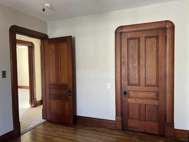 unfurnished bedroom featuring dark hardwood / wood-style flooring