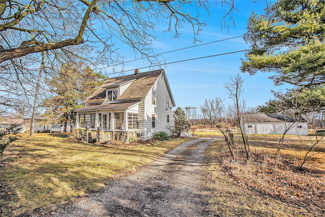 view of property exterior featuring a yard and covered porch