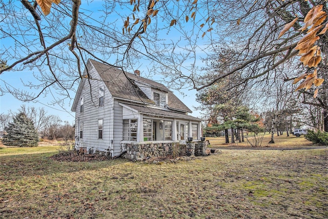 view of side of home with a yard