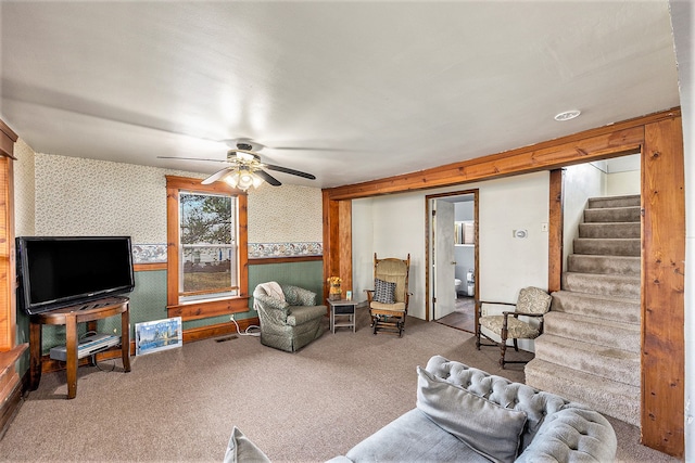 living room with ceiling fan and carpet