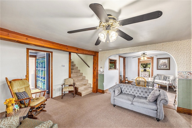 carpeted living room with ceiling fan