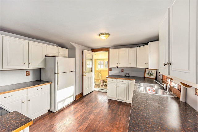 kitchen with dark hardwood / wood-style floors, white refrigerator, white cabinetry, and sink