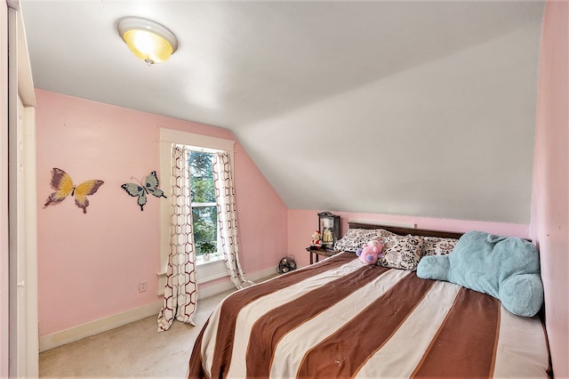 bedroom featuring lofted ceiling and light carpet