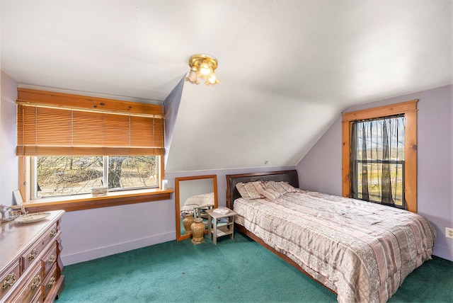 bedroom featuring dark colored carpet, multiple windows, and lofted ceiling