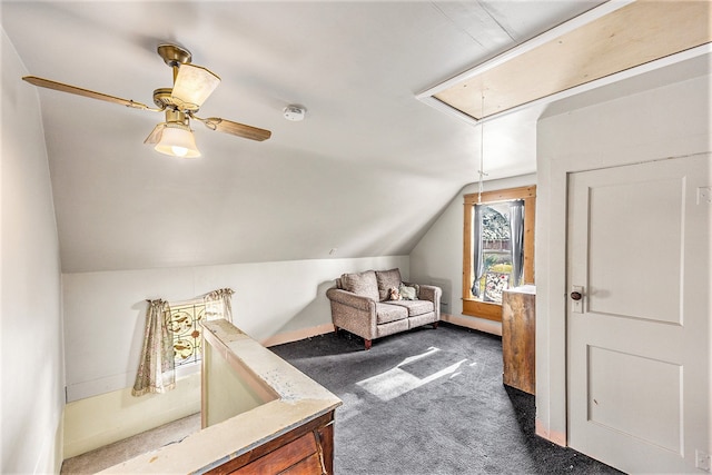 additional living space featuring dark carpet, ceiling fan, and lofted ceiling