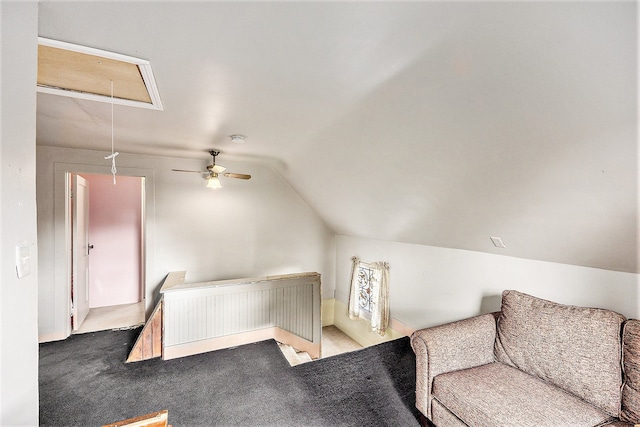 interior space featuring ceiling fan, light carpet, and vaulted ceiling