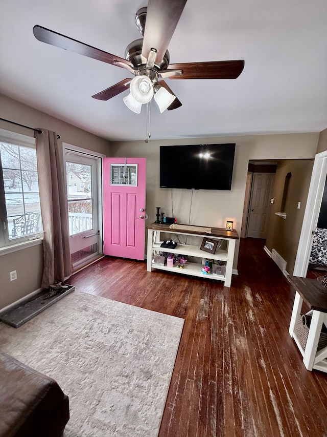 living room featuring dark hardwood / wood-style floors and ceiling fan