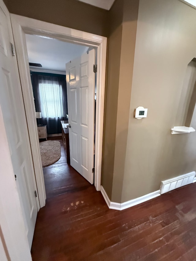 hallway with dark wood-type flooring