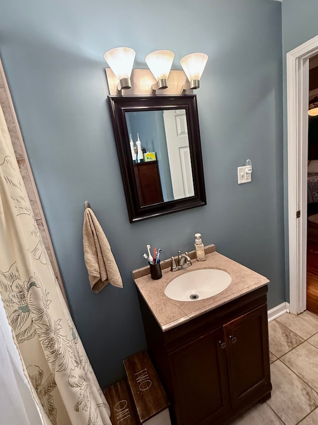 bathroom featuring tile patterned flooring and vanity