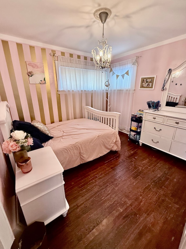 bedroom with a notable chandelier, ornamental molding, and dark wood-type flooring