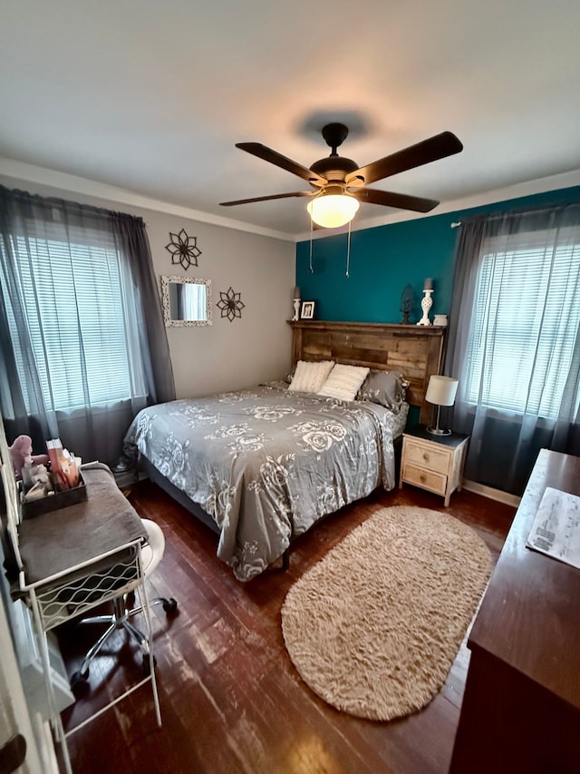 bedroom featuring ceiling fan, dark hardwood / wood-style flooring, and ornamental molding