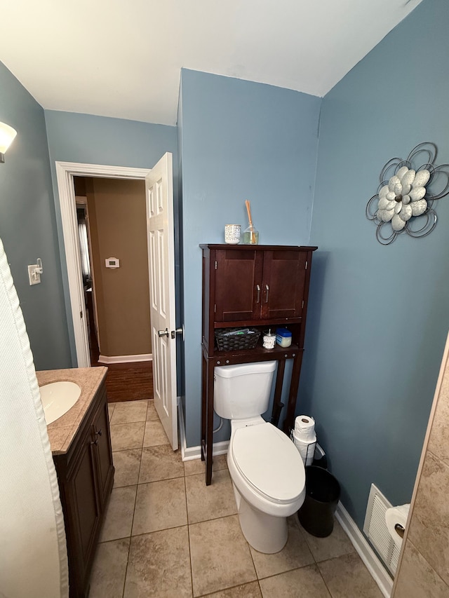 bathroom featuring tile patterned flooring, vanity, and toilet