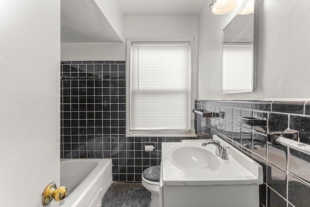 bathroom featuring tile patterned floors, vanity, toilet, and tile walls