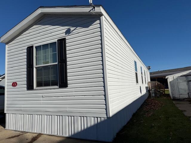 view of side of home with an outbuilding