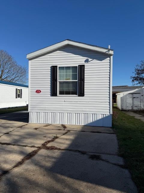 view of side of home featuring driveway