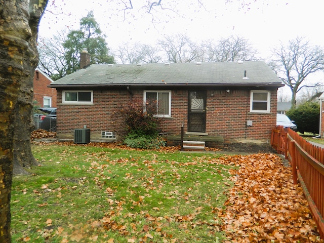 back of house with a yard and central AC unit