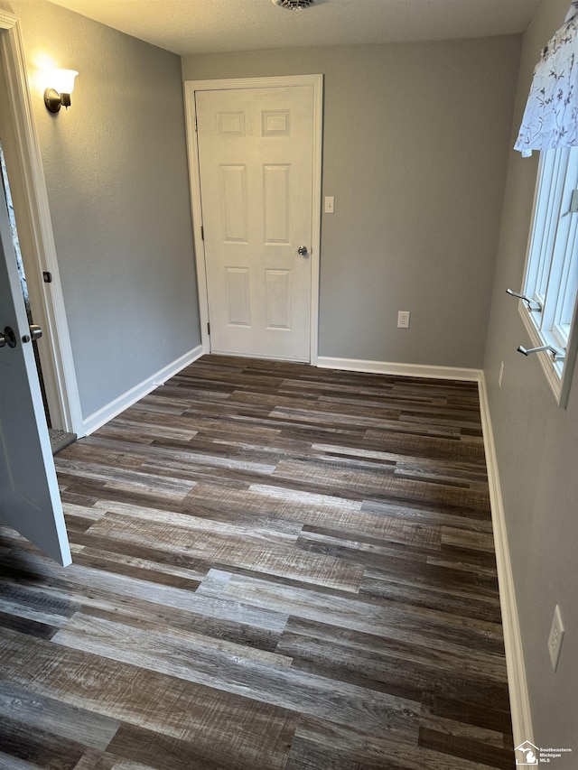 empty room featuring dark hardwood / wood-style floors