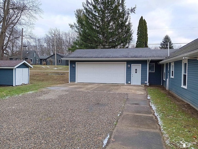 ranch-style home with a storage shed, a front lawn, and a garage