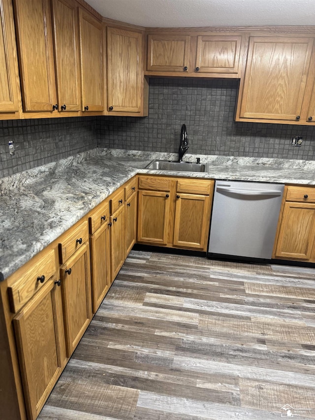 kitchen with backsplash, dishwasher, dark hardwood / wood-style floors, and sink