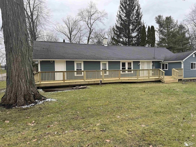 back of house with a wooden deck and a yard