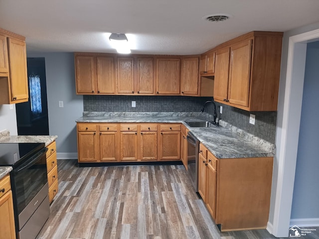 kitchen with dishwasher, black range with electric stovetop, sink, and tasteful backsplash