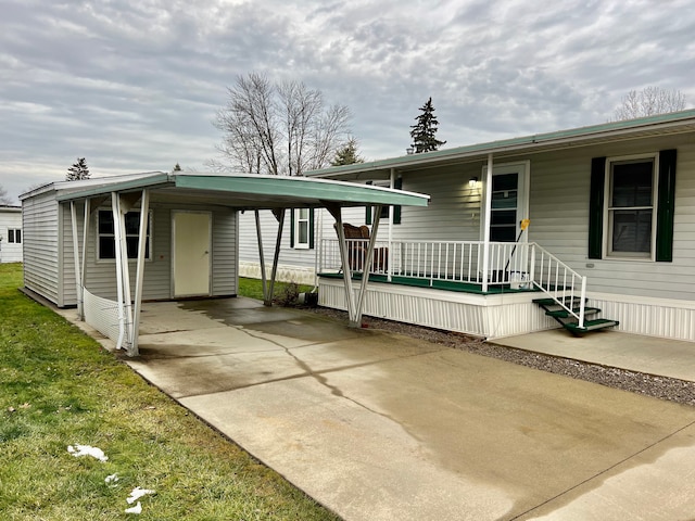 view of front of home featuring covered porch and a carport