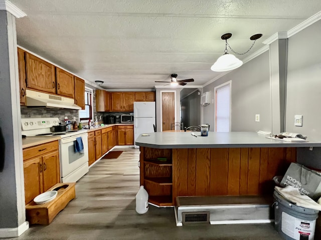 kitchen featuring ceiling fan, hanging light fixtures, tasteful backsplash, crown molding, and white appliances