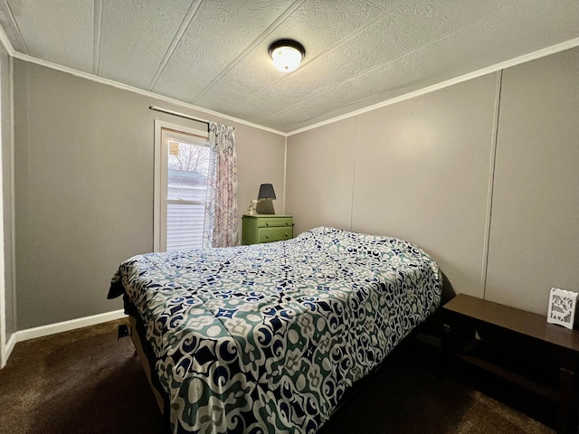 bedroom with a textured ceiling, dark carpet, and crown molding