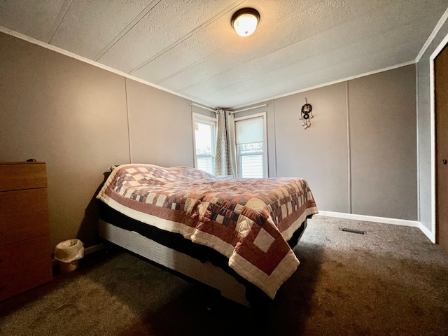 bedroom featuring carpet flooring, ornamental molding, and a textured ceiling