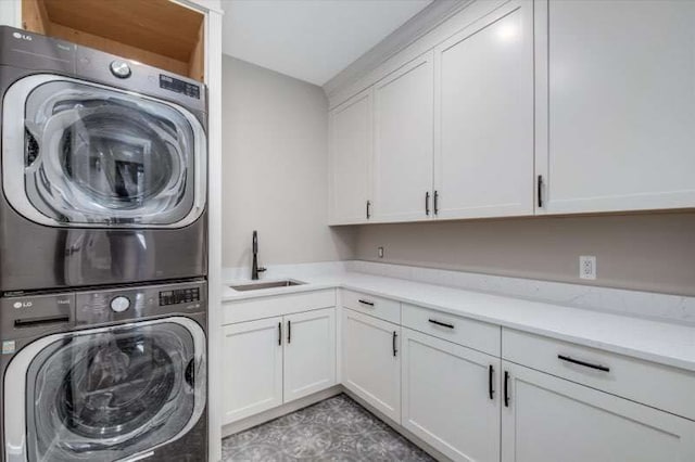 washroom with stacked washer / dryer, sink, and cabinets