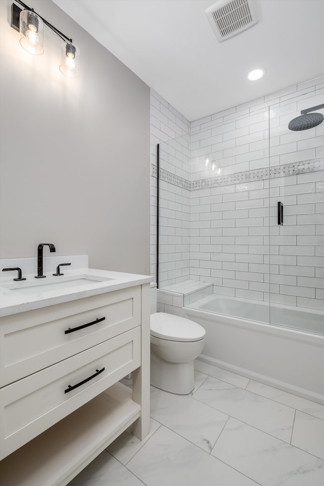 full bathroom featuring vanity, toilet, and bath / shower combo with glass door