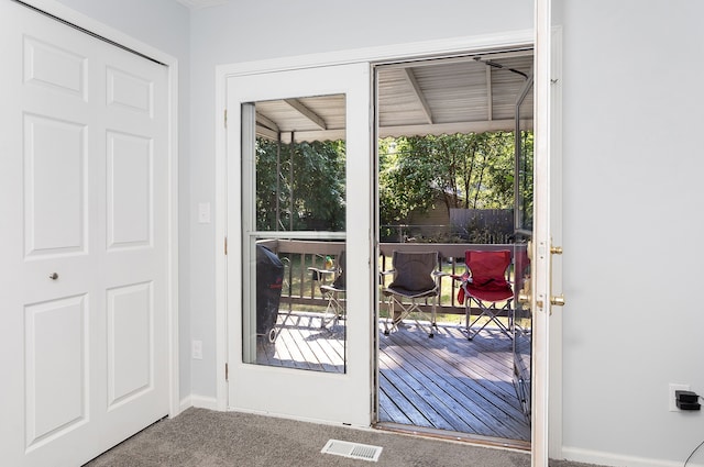 entryway featuring carpet flooring and a healthy amount of sunlight