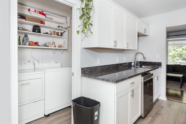 washroom with washer and dryer, light hardwood / wood-style floors, and sink