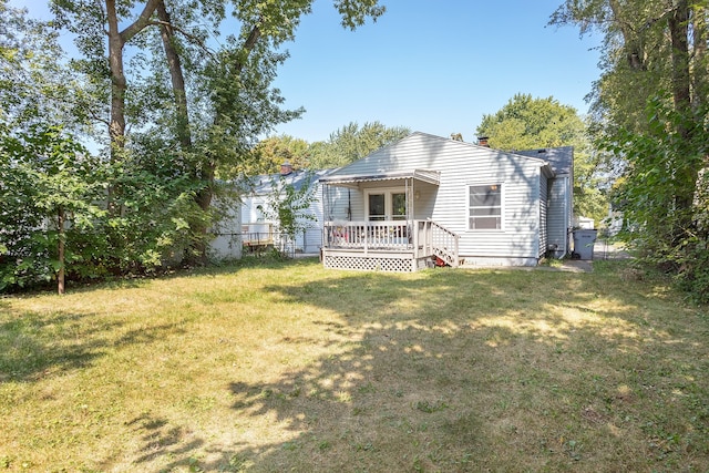 back of house featuring a yard and a deck