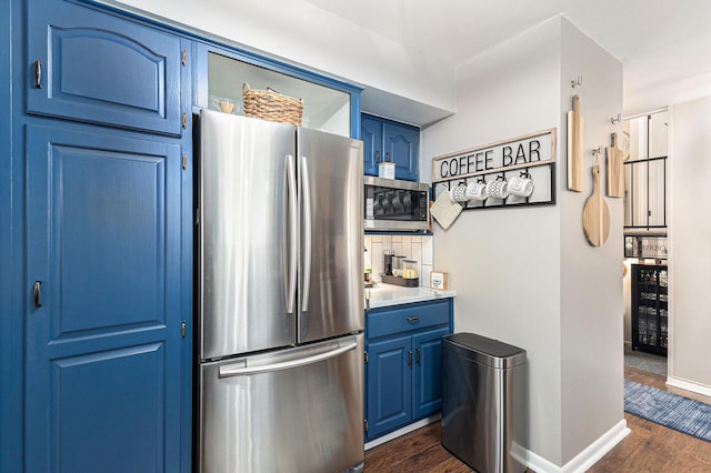 kitchen featuring beverage cooler, appliances with stainless steel finishes, dark wood-type flooring, light countertops, and blue cabinetry