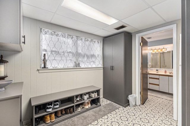 mudroom featuring visible vents and a drop ceiling