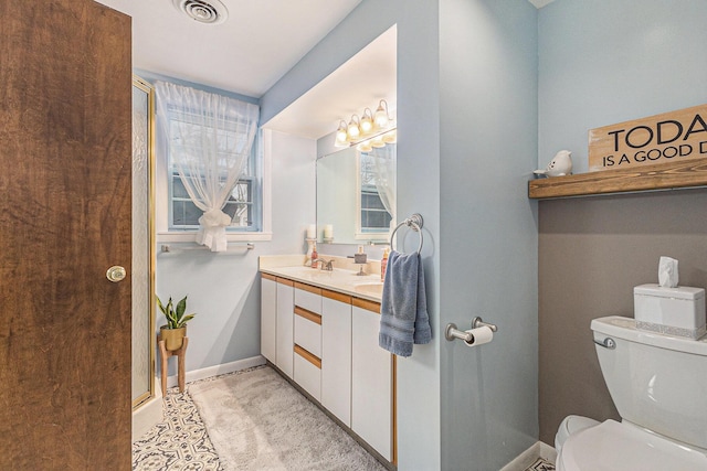 bathroom with toilet, a sink, visible vents, baseboards, and double vanity