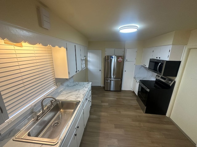 kitchen featuring dark hardwood / wood-style flooring, sink, white cabinets, and appliances with stainless steel finishes