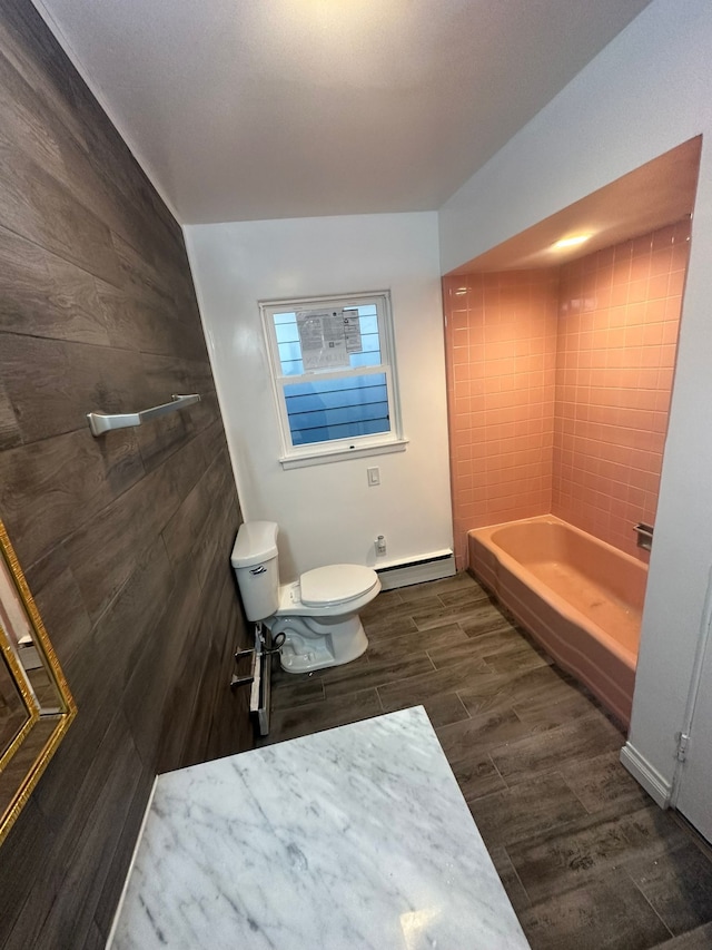 bathroom with toilet and a baseboard heating unit